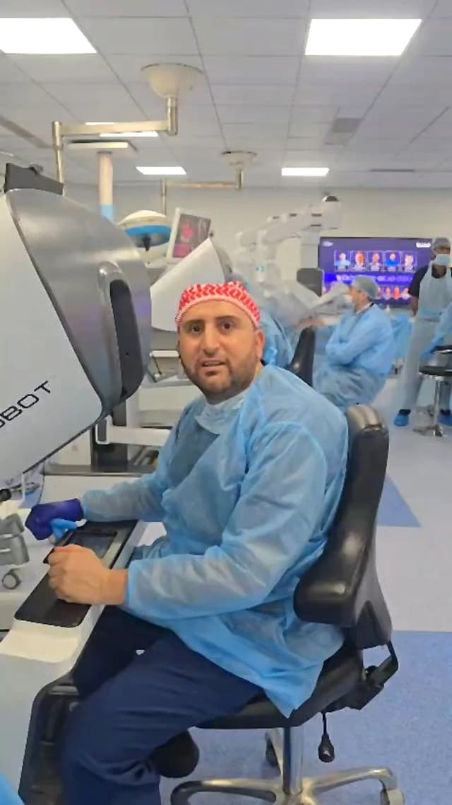 Dr. Mohammad Al-Zaitawi at the surgical robot console for robotic bariatric surgery in Amman, Jordan