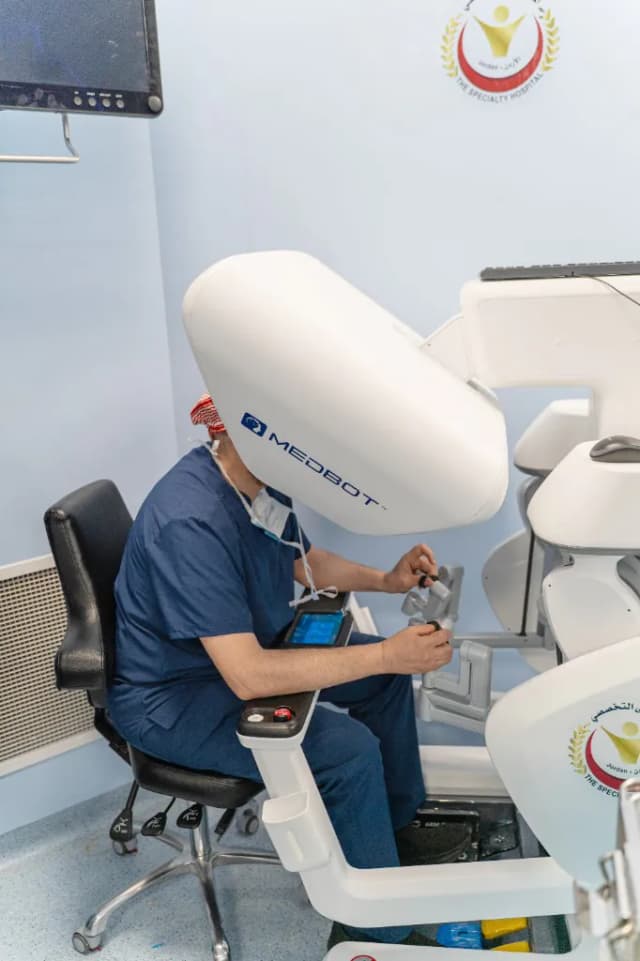 Dr. Mohammad Al-Zaitawi at the MicroPort MedBot robotic console at the Specialty Hospital, Amman, during Jordan's first robotic sleeve gastrectomy