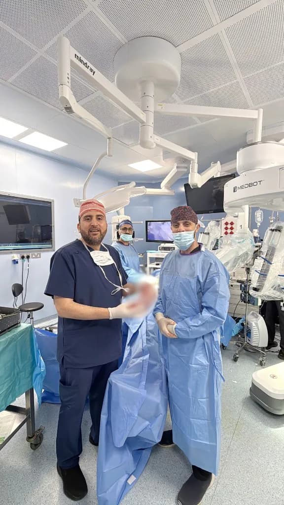 Dr. Mohammad Al-Zaitawi with a member of the surgical team in the robotic operating room at the Specialty Hospital after Jordan's first robotic sleeve gastrectomy